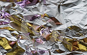 Detailed close up view on colorful lightened aluminum foil textures