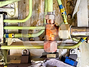 Detailed image of inside of an airplane. Hydraulic lines, valves, tubes, switches and wires