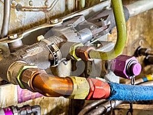 Detailed image of inside of an airplane. Hydraulic lines, valves, tubes, switches and wires