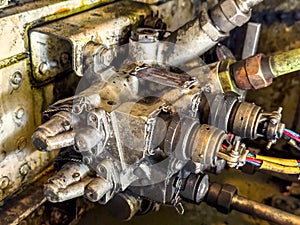 Detailed image of inside of an airplane. Hydraulic lines, valves, tubes, switches and wires