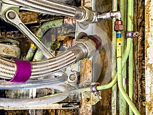 Detailed image of inside of an airplane. Hydraulic lines, valves, tubes, switches and wires