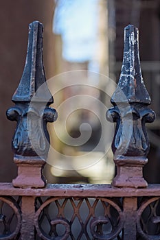 Detailed iron work ornament atop a gate in Harlem, New York, NY, USA