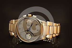 Gold wrist watch with metal bracelet, close-up photo