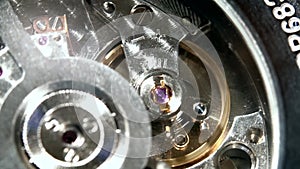 Detailed macro - watch mechanism movement, closeup, only moving spring in focus.