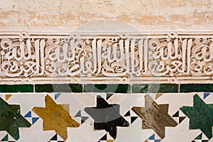 Detailed panel of the intricate patterns and mosaic on a wall of the Alhambra Palace, Granada, Spain