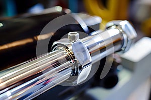 detailed photo of a chromeplated rod of a hydraulic cylinder