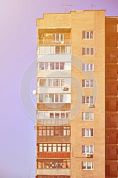 Detailed photo of multi-storey residential building with lots of balconies and windows. Hostels for poor people in Russia and Ukr