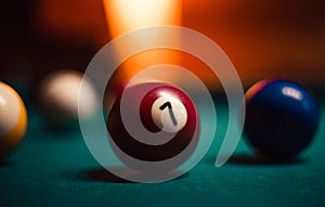 Detailed photo of pool billiard balls on cozy warm backround with orange lighting. Close up image of colorful billiard balls