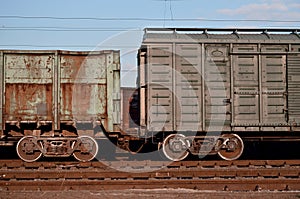 Detailed photo of railway freight car. A fragment of the component parts of the freight car on the railroad in dayligh