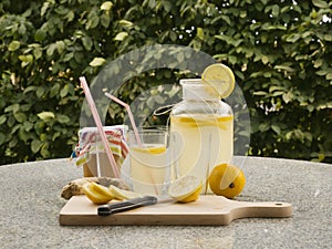 Detailed Picture of all ingredients neccesary to cook a homemade lemonade consist from water, lemon, ginger and glass of honey.
