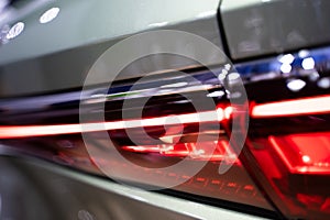 Detailed rear view of modern car back lights. bokeh light background