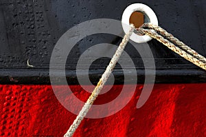 Tethered red and black Tug Boat at the marina photo