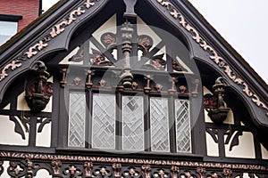 detailed shot of ornate woodwork on the gable of a tudor style house