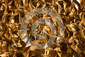 Detailed texture of glittering golden foil surface. Glamour background