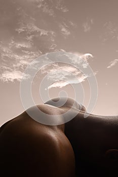 Detailed texture of human skin. Close up shot of young african-american male body like landscape with the sky background