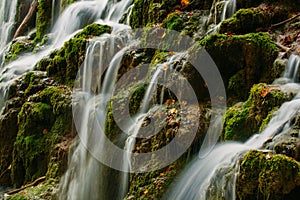 Detailed view of a beautiful crystal watered waterfall in the forest