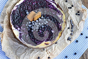 detailed view on a brindle cheesecake of forest blueberries made of caramel biscuits