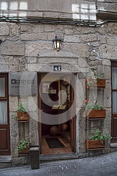 Detailed view of classic restaurant "CortiÃƒÂ§o" entrance, stone facade, entrance door with street retro wall lamp
