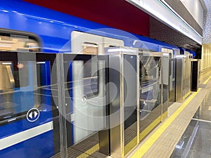 Detailed view of closed, sliding doors seen on a commuter train, located at the station platform. This carriage allows bicycles to