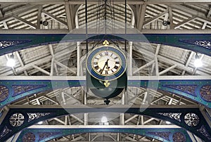 Detailed view of the colourful wrought ironwork and clock at Smithfield meat market, London UK