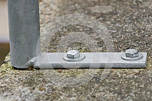 Detailed view of construction bolts bolted to concrete foundations