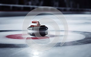 Detailed view of a curling stone at the central ring of the score house during a match