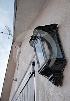 Detailed view of detached garage showing a PIR lighting system and CCTV camera.