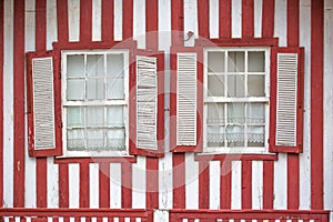 Detailed view of front facade windows of typical Costa Nova beach house, colorful striped wooden beach houses