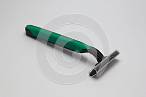 Close-Up of Green Plastic Razor on White Background
