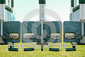 Detailed view of a horse and jockey turnstile seen from the front gate, located on a race course track.