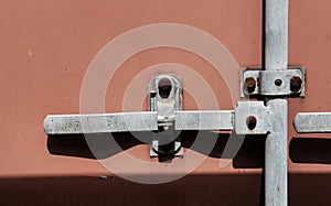 Detailed view of the locking system on a standard shipping container.