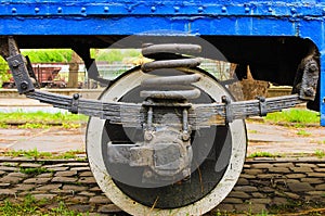 Detailed view of metal wheel of old tram. Steel wheel tram. old vintage tram wheel with shadows stay on rail