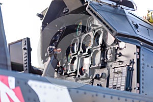 Detailed view of military helicopter cockpit with control stick and dashboard with instruments
