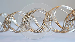 A detailed view of a piece of wire bent and contorted into a delicate spiral shape. The wire appears metallic but also
