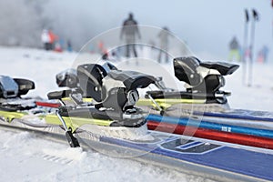 Detailed view of the ski bindings and skis lying on the piste