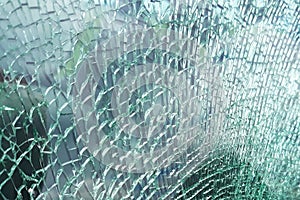 Detailed view of texture of a broken and slivered car window glass