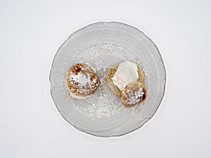 Detailed view of traditional Swedish semla, or fastlagsbulle, with whipped cream, almond paste and confectioners\' sugar.