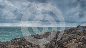 Detailed view of volcanic coastline with high cliffs and waves breaking over volcanic rocks, Portugal.