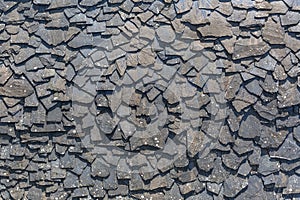 Detailed view of wall texture randomly lined with slate panels, typical and traditional shale stone material