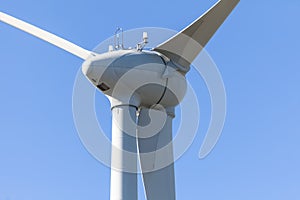 Detailed view of a wind turbine or wind mill, details at the main components: rotor blades, hub, nacelle and generator