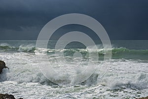 Detailed winter storm wave breaking and splashing on shore