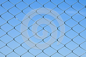 Detailed wire fence against blue sky