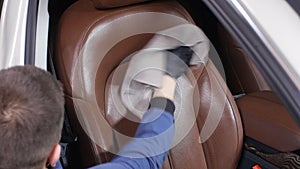 Detailing and cleaning of interior front seats at luxury modern cars. Car care concept
