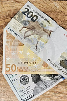 Details in 200 Reais, 100 Dolllars, 50 Euros notes - Brazilian, USA, Europe Money Photography