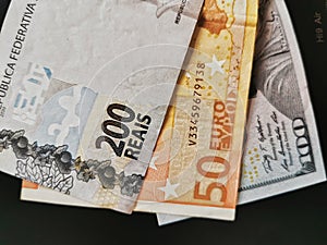 Details in 200 Reais, 100 Dolllars, 50 Euros notes - Brazilian, USA, Europe Money Photography