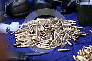 Details with 5.56 NATO ammunition on a table on a shooting range