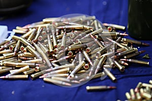 Details with 5.56 NATO ammunition on a table on a shooting range