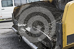 Details of Asphalt paver machine during road construction and repairing works. A paver finisher, asphalt finisher or