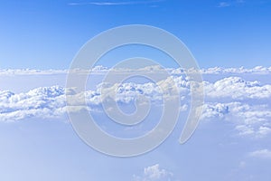 Details of a beautiful cloudy sky from aerial view. Airplane view above clouds.