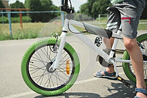 Details: bicycle chain wheel frame, parts bicycle wheel, cycling road bike frame. Cropped view of child boy riding bike